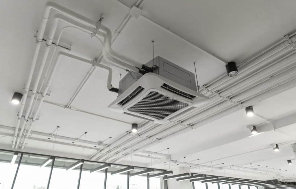 Ceiling mounted cassette type air conditioner in building system work. Ventilation compressor.