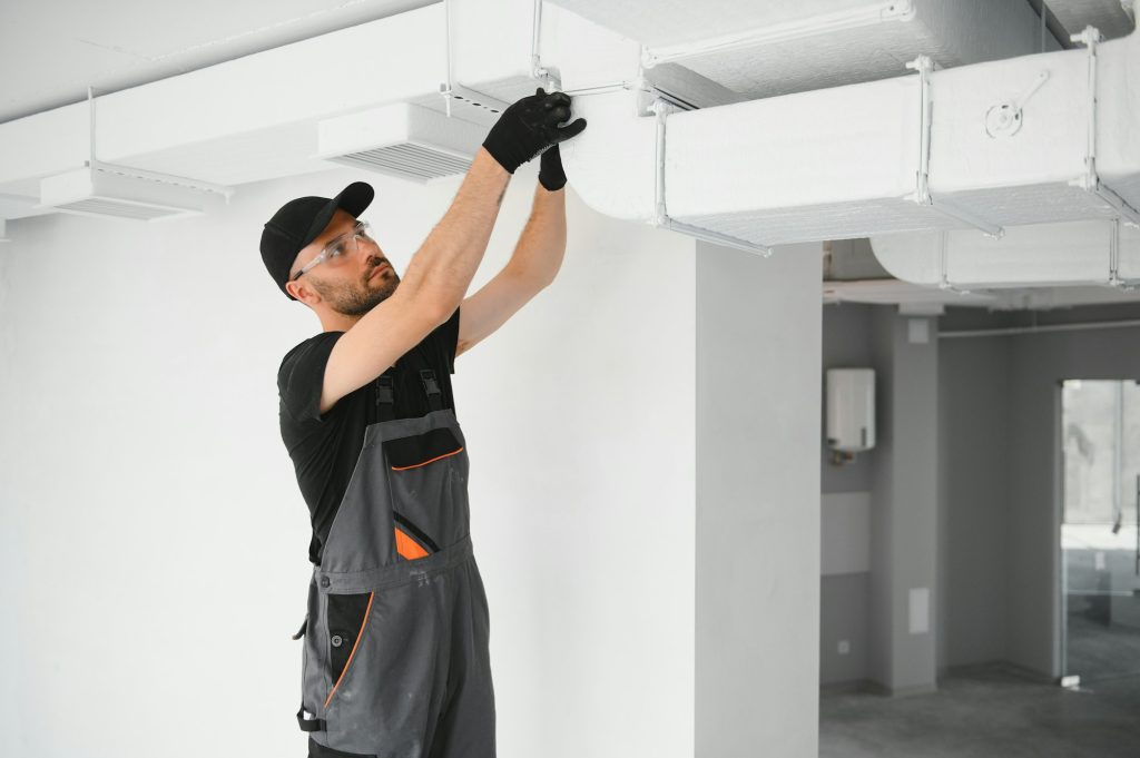 hvac technician at work. ventilation, heating system maintenance and repair