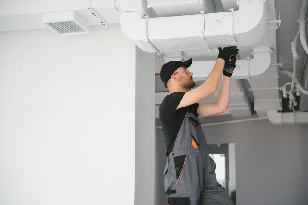 hvac technician at work. ventilation, heating system maintenance and repair