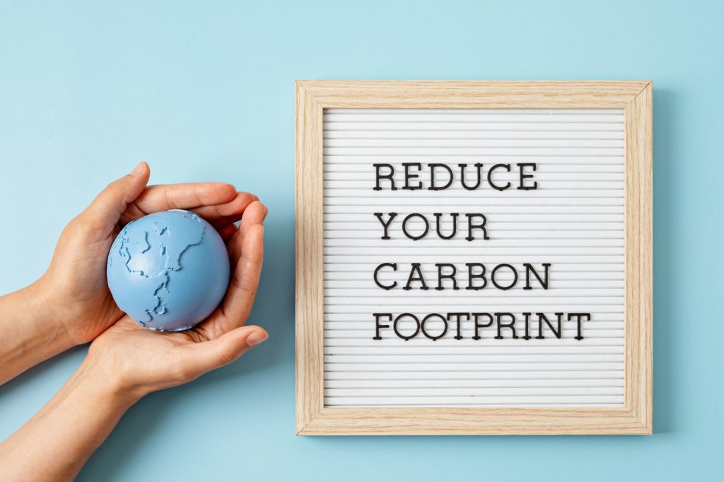 Letter board with text reduce your carbon footprint