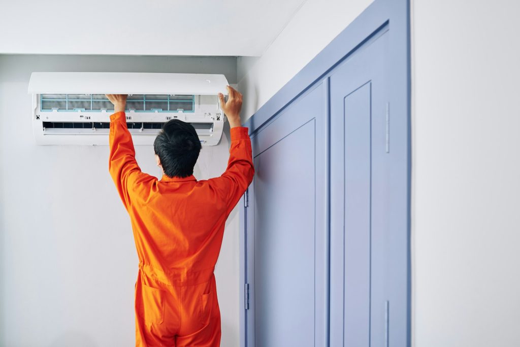 Worker installing air conditioner